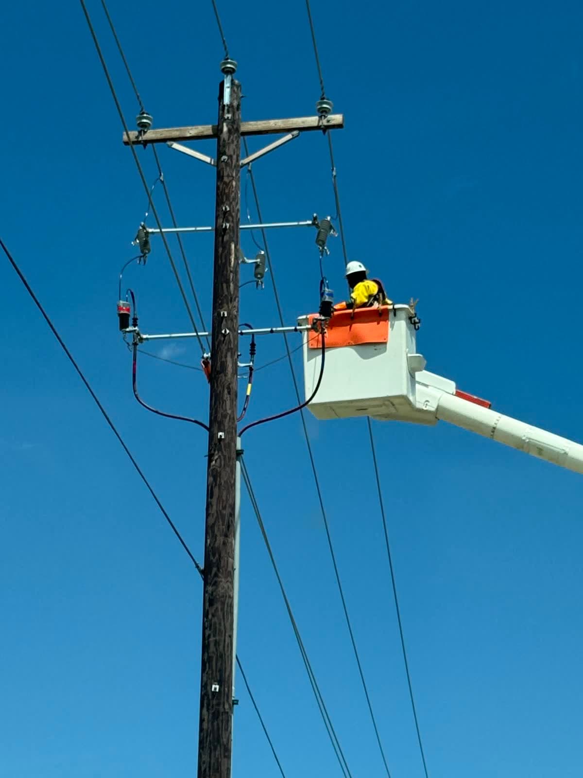 Electrical crew completing cable termination work.