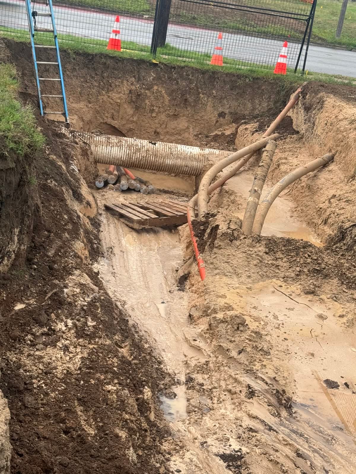 Excavation prepared for a commercial duct bank installation.